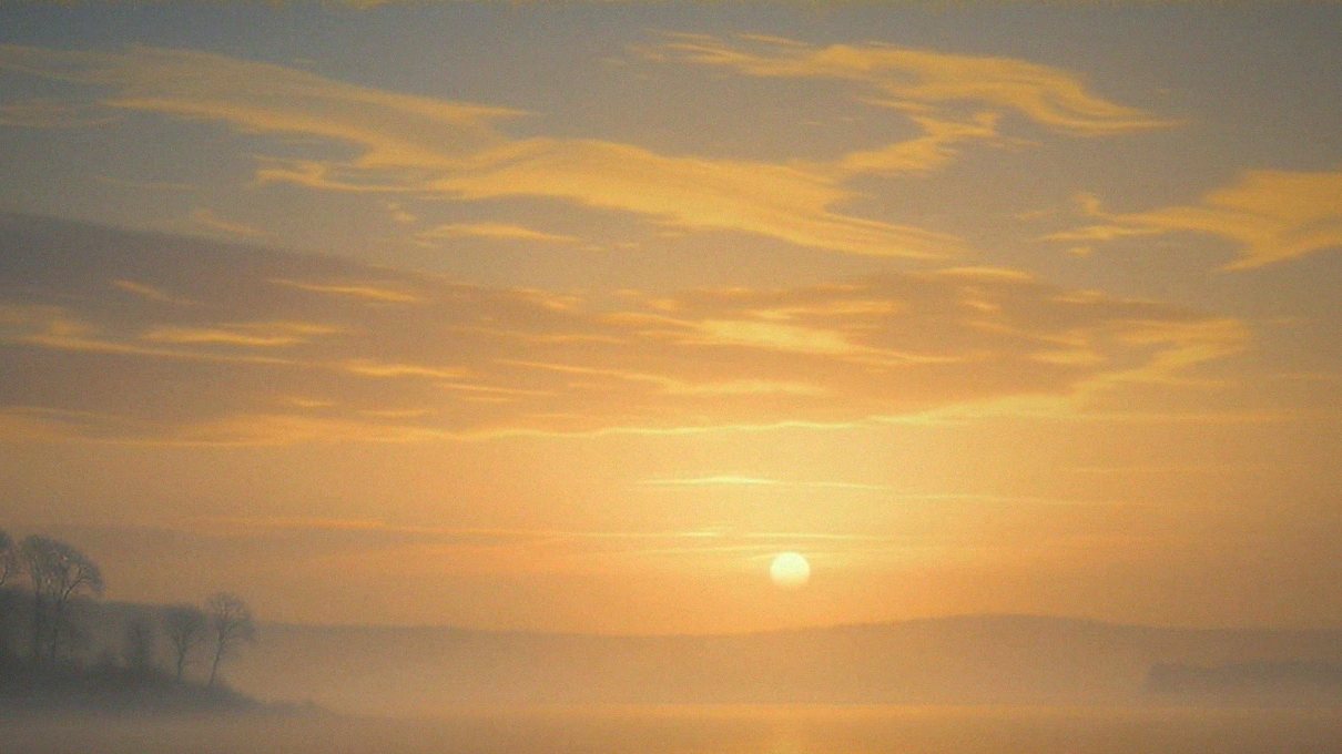 Sunrise over still water