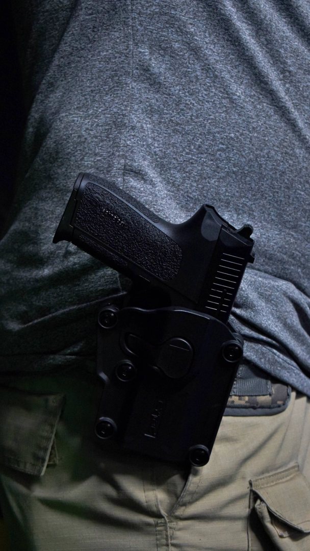 A holstered pistol on a hip