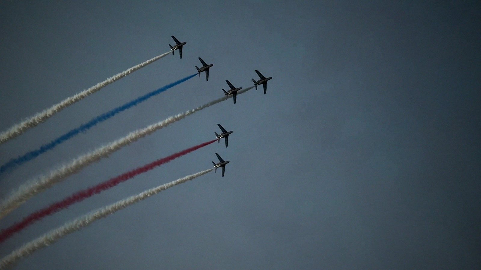 Jets trailing red, white and blue smoke
